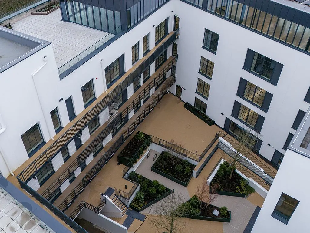 The Parklife Building courtyard with planters and terraces above occupied floors